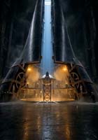 A person stands in front of a massive, illuminated industrial gate with gears and pipes, bathed in dramatic light streaming down from above inside a dark, cavernous structure.